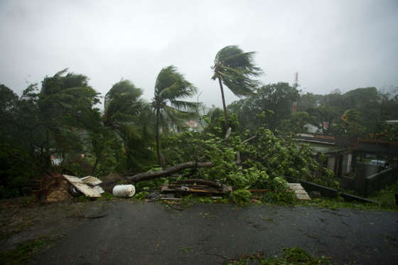 Slide 1 of 20: A picture taken on September 19, 2017 shows the powerful winds and rains of hurricane Maria battering the city of Petit-Bourg on the French overseas Caribbean island of Guadeloupe.