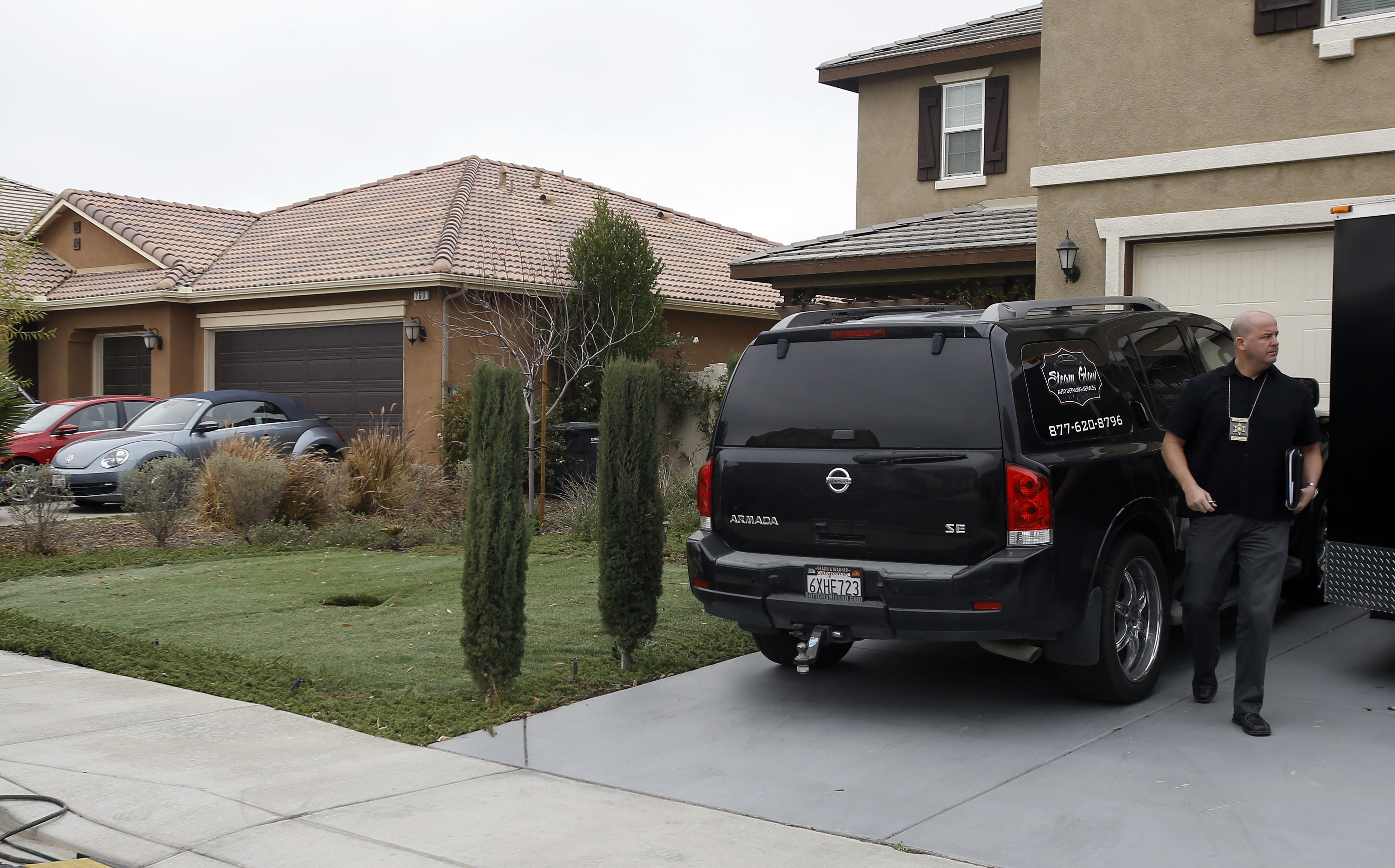 Slide 2 of 12: Detective walks next to a home Tuesday, Jan. 16, 2018, where police arrested a couple on Sunday accused of holding 13 children captive, in Perris, Calif.