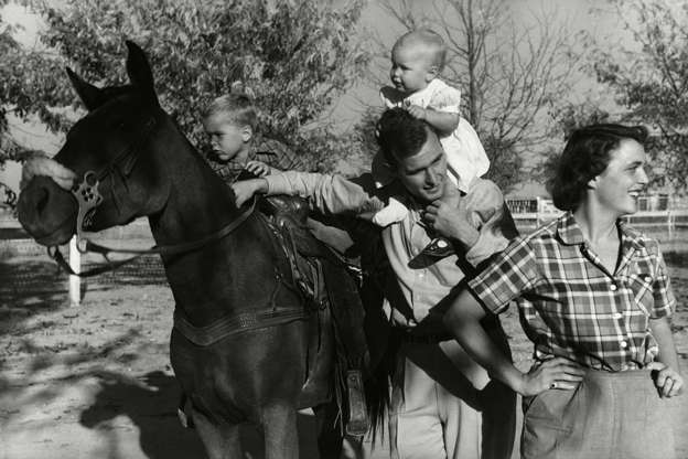 Slide 3 of 36: George H. W. Bush with his wife, Barbara, and their children Pauline and George W. on horse in the yard of their Midlands, Texas ranch circa 1950.