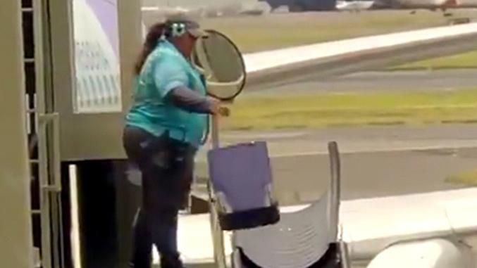 Airport worker tossing luggage sparks