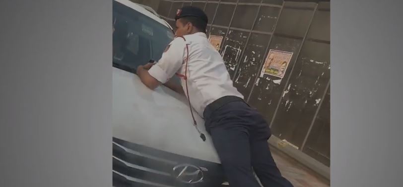 tries escape, clings onto SUV's