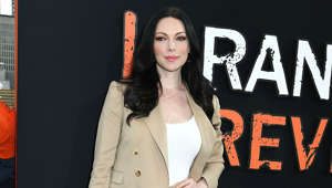 Laura Prepon holding a sign posing for the camera: The ‘Orange Is the New Black’ star is actually more orange than black in the hair department. In the series about Litchfield women's prisons, we saw her with sleek, black hair, playing the character Alex. She starred in ‘That 70s Show’ and kept her natural red hair but has dyed it many colours over the years, saying: “My hair can be any colour and I'll always have fun.”