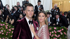 Tom Brady, Gisele Bundchen standing in front of a crowd posing for the camera