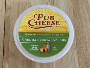 a wooden table: Trader Joe's jalapeño pub-cheese dip was both spicy and cheesy. Savanna Swain-Wilson for Insider