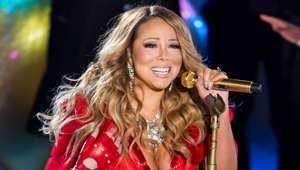 Mariah Carey sitting on a stage: In high school, Mariah was often absent from her classes and was given the nickname "Mirage" by her classmates.  She eventually enrolled in beauty school to help pay her rent but dropped out a year later.  Mariah said: "I started beauty school in the 11th grade, and a year later I was officially a beauty school dropout."