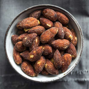 a bowl of food: It's hard to find a simpler, easier keto snack than this: a handful of almonds. Naturally high in healthy fat, nutrient-dense almonds pack a punch of protein, fiber, vitamin E, magnesium and copper. Nutrition Facts 1 ounce whole, roasted, salted kernels (28g): 167 calories, 14.8g fat (1.1g saturated fat), 0.0mg cholesterol, 94.9g sodium, 5.4g carbohydrate (1.4g sugars, 3.3g fiber), 6.2g protein.