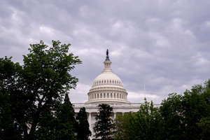 a statue in front of a building: An exterior view of the U.S. Capitol building.