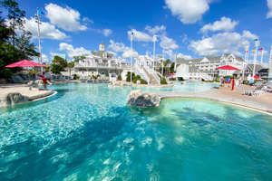 a group of people swimming in a pool of water: Stormalong Bay pool at Disney Beach Club and Yacht Club. (Photo by Summer Hull/The Points Guy)