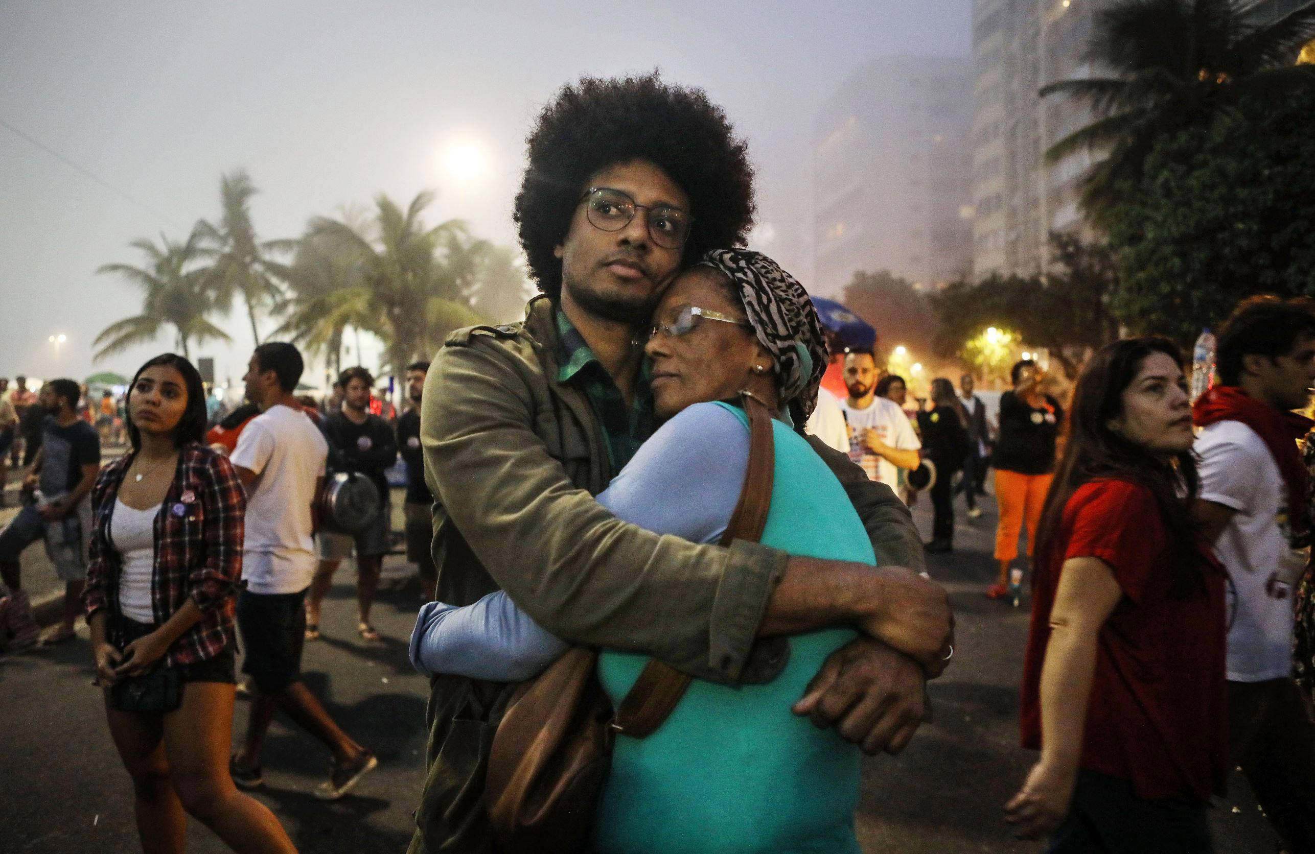 Slide 1 of 101: RIO DE JANEIRO, BRAZIL - MAY 28: Orlando Caldeira embraces his mother Georgina at a demonstration and concert calling for direct presidential elections on May 28, 2017 in Rio de Janeiro, Brazil. President Michel Temer is enmired in allegations of endorsing bribery in a scandal which threatens to bring down his brief presidency. (Photo by Mario Tama/Getty Images)