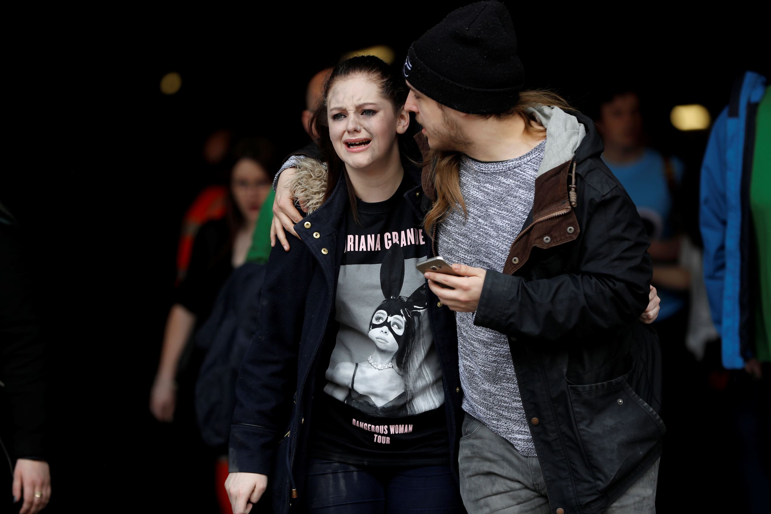People rush out of the Arndale shopping centre as it is evacuated in Manchester,...