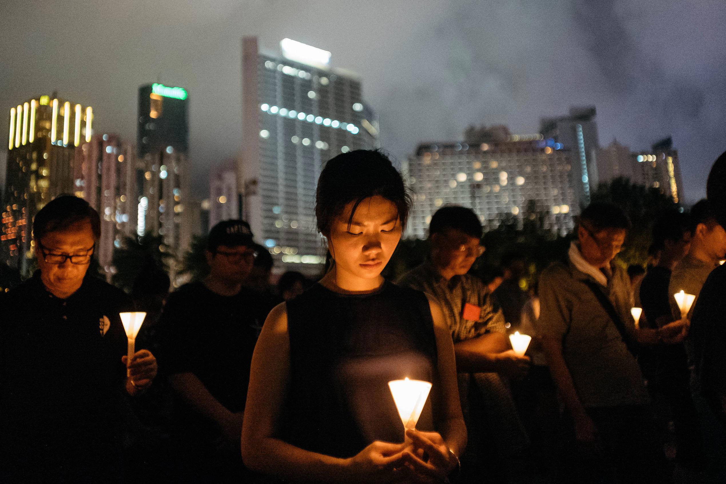 Slide 1 of 98: HONG KONG, HONG KONG - JUNE 04: Participants take part at the candlelight vigil as they hold candles at Victoria Park on June 4, 2017 in Hong Kong, Hong Kong. Thousands of people in Hong Kong participated in an annual candlelight vigil in Hong Kong on June 4 to commemorate the killing of protesters in Beijing's Tiananmen Square in 1989. (Photo by Anthony Kwan/Getty Images)