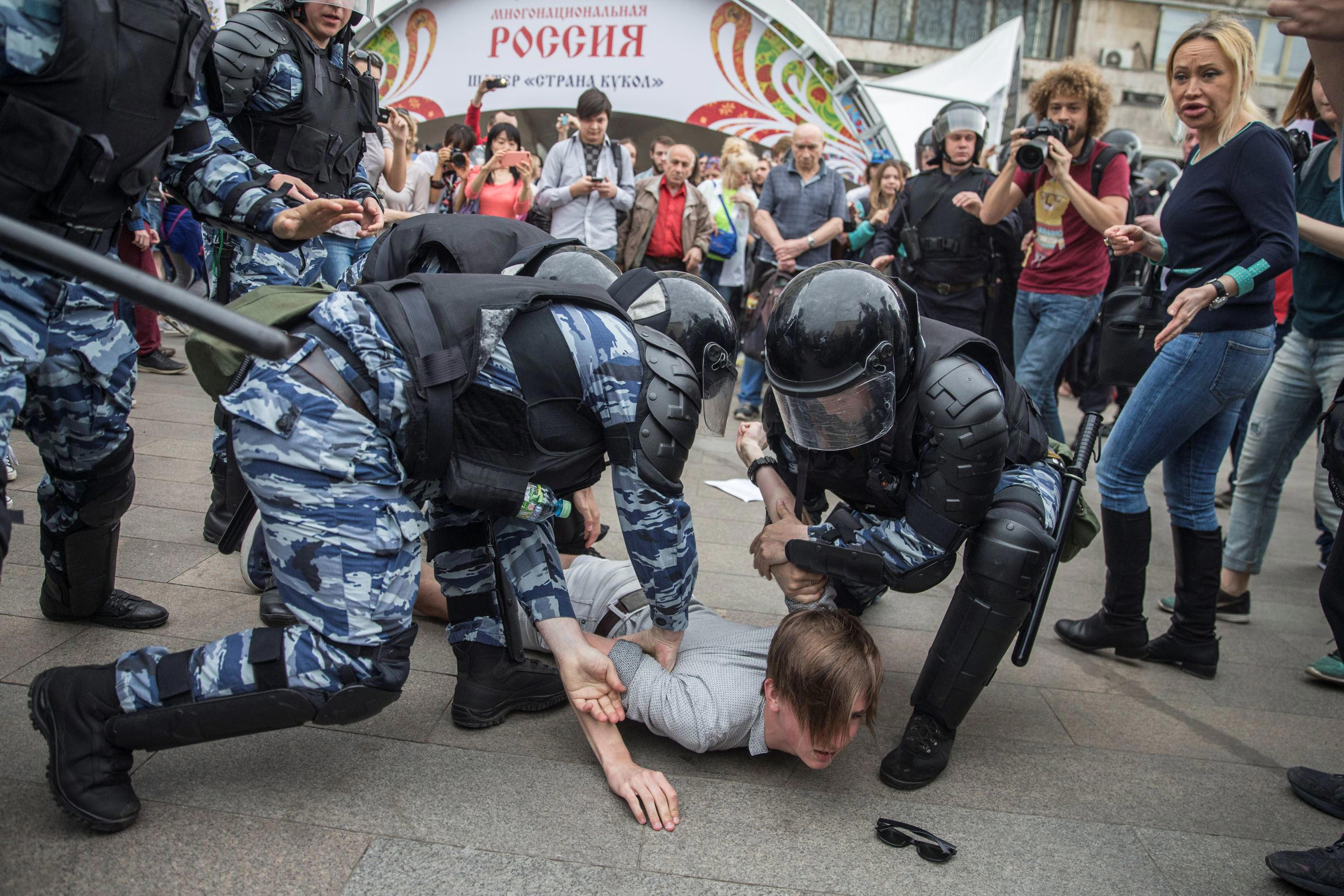 Slide 1 of 101: Police detain a protester In Moscow, Russia, Monday, June 12, 2017. Demonstrators in Monday's opposition protests across Russia say they are fed up with endemic corruption among officials. The protest gatherings in cities from Far East Pacific ports to St. Petersburg were spearheaded by Alexei Navalny, the anti-corruption campaigner who has become the Kremlin's most visible opponent. (Evgeny Feldman/Pool Photo via AP)