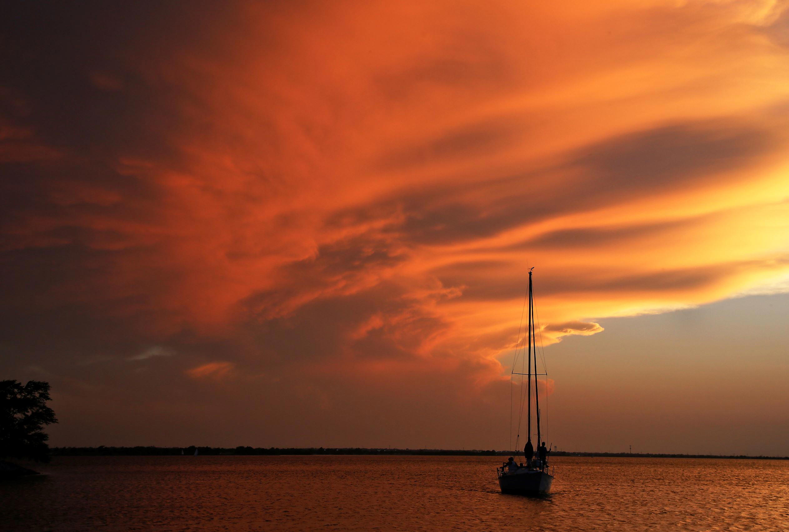 Slide 1 of 99: A boat returns to the harbor as the sun sets at Lake Hefner in Oklahoma City, Wednesday, June 14, 2017. (AP Photo/Sue Ogrocki)