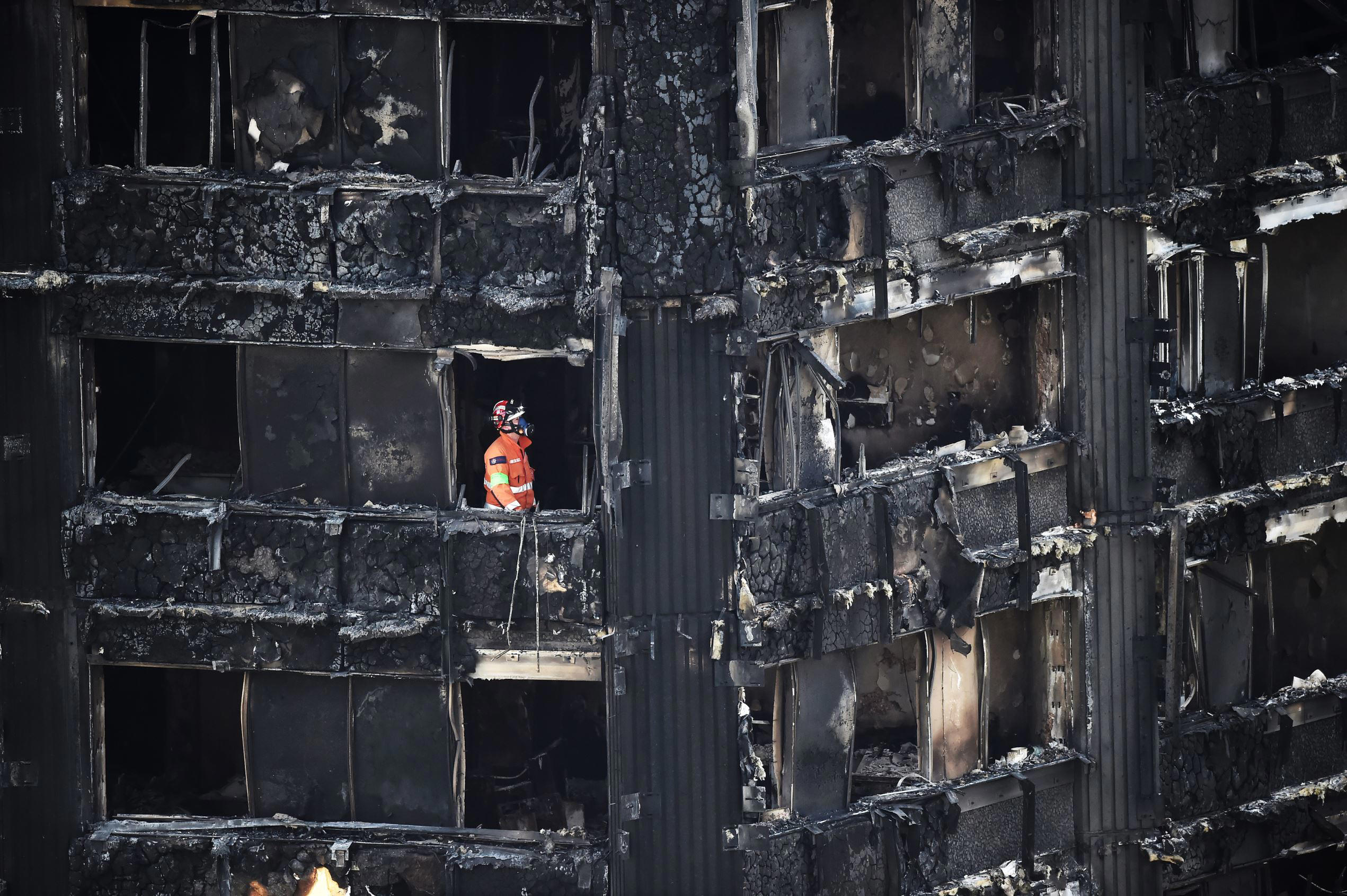 Slide 1 of 101: A member of the emergency services works inside the Grenfell apartment tower block in North Kensington, London, Britain, June 17, 2017. REUTERS/Hannah McKay