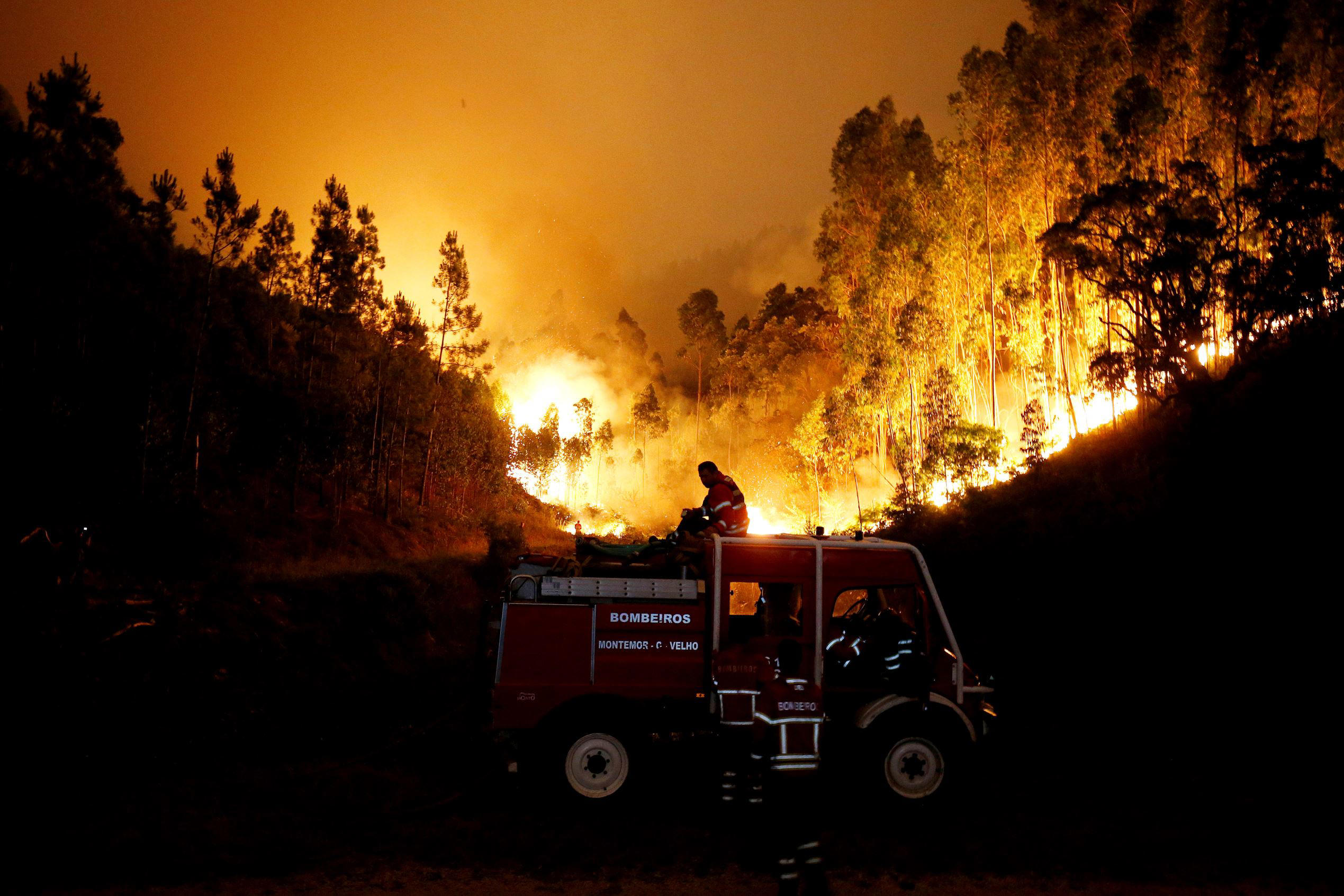 Slide 1 of 102: Firefighters work to put out a forest fire near Bouca, in central Portugal, June 18, 2017.  REUTERS/Rafael Marchante     TPX IMAGES OF THE DAY