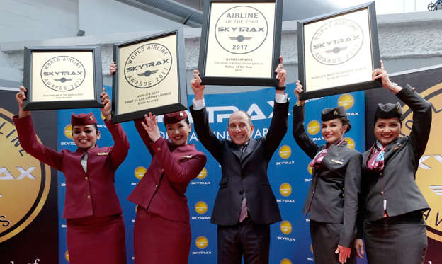 Slide 1 of 26: Akbar Al Baker, Qatar Airways Chief Executive Officer, poses with flight crew members after his company was announced the World's Best Airline along with other awards at the SKYTRAX 2017 World Airline Awards during the 52nd International Paris Air Show at Le Bourget Airport on June 20, 2017, in Paris, France.