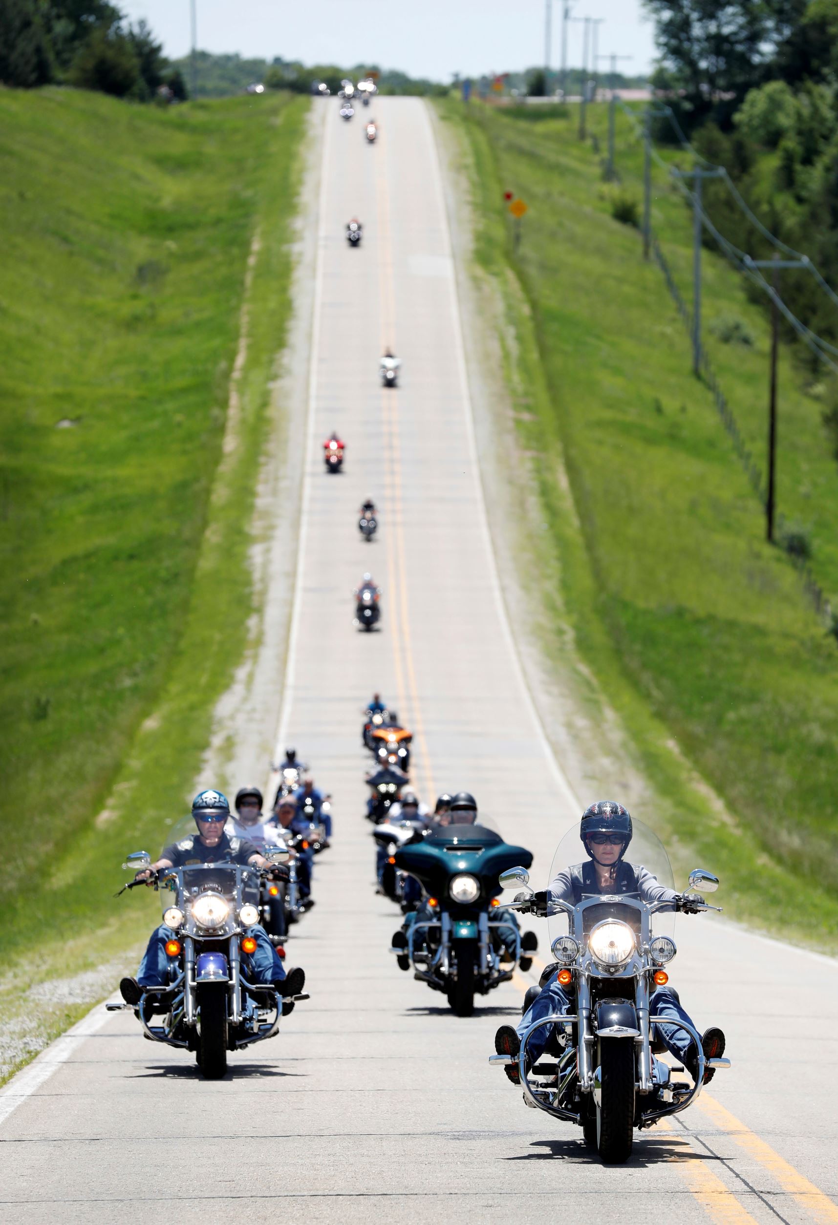 Slide 17 de 36: U.S. Sen. Joni Ernst, R-Iowa, right, leads a group of motorcyclists to her annual fundraiser, Saturday, June 3, 2017, in Boone, Iowa. (AP Photo/Charlie Neibergall)