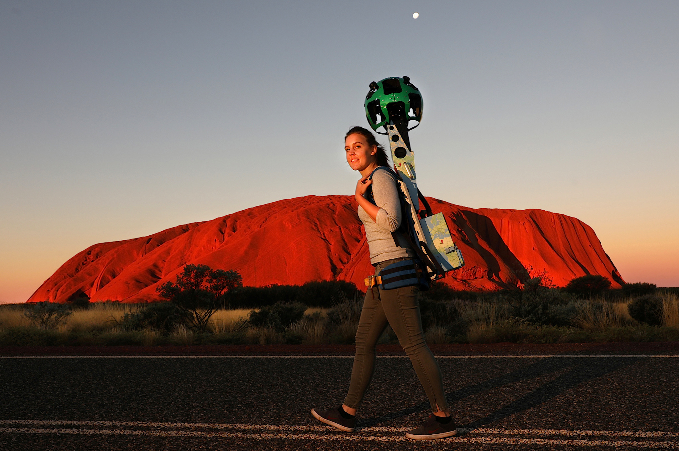 Slide 28 de 36: A handout image of Lindsey Dixon carrying the Google Street View Trekker camera on her back as part of a promotional event in front of Uluru, also known as Ayers Rock, located in the Northern Territory, Australia, June 7, 2017. Chris Pavlich/Handout via 