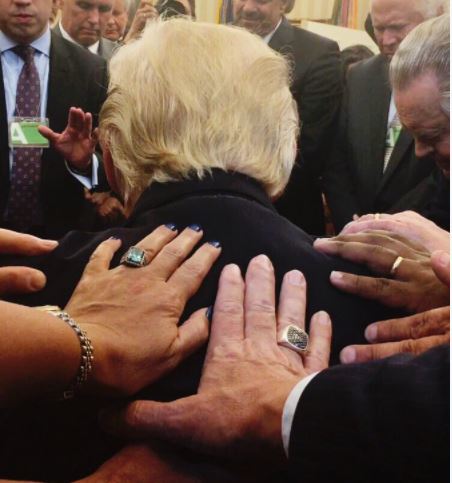 Photo pastors laying hands Trump