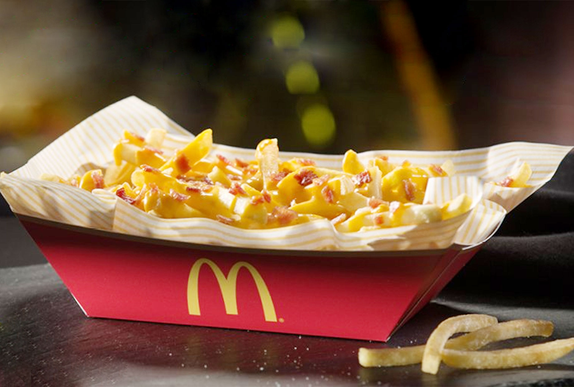 Cheesy fries with bacon coming