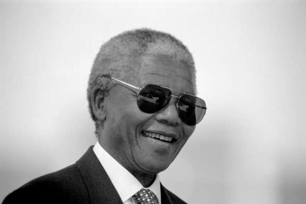 Slide 2 of 21: Former President Nelson Mandela of South Africa smiles as he greets people at a pre-election rally weeks before the historic democratic election on April 15, 1994 in Soweto, South Africa.