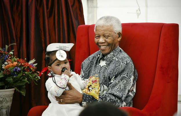 Slide 1 of 21: Michai'ah Simons sits with Nelson Mandela at the Nelson Mandela childrens fund annual celebration. The occasion marks the dedication of this site for the Nelson Mandela Childrens Hospital at Wits Education Campus, Johannesburg.