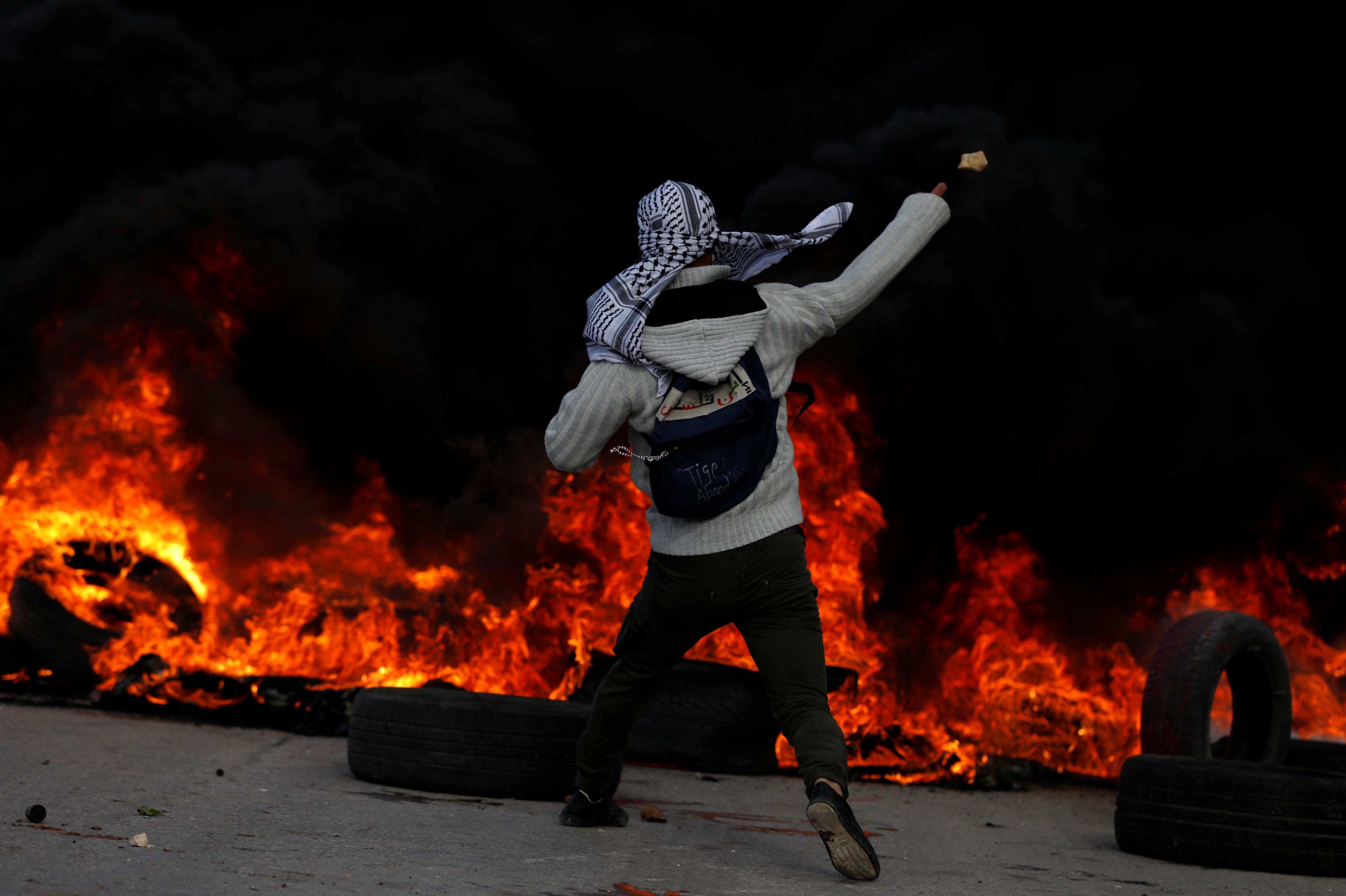 Scores injured, dead Palestinians hold