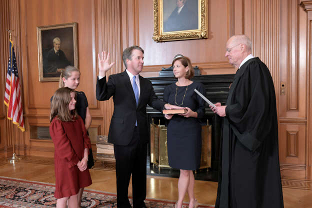 Slide 1 of 90: Judge Brett Kavanaugh is sworn in as an Associate Justice of the U.S. Supreme Court by retired Justice Anthony M. Kennedy as his wife Ashley holds the bible and his daughters Liza and Margaret look on in a handout photo provided by the U.S. Supreme Court and taken at the Supreme Court building in Washington, U.S., October 6, 2018.