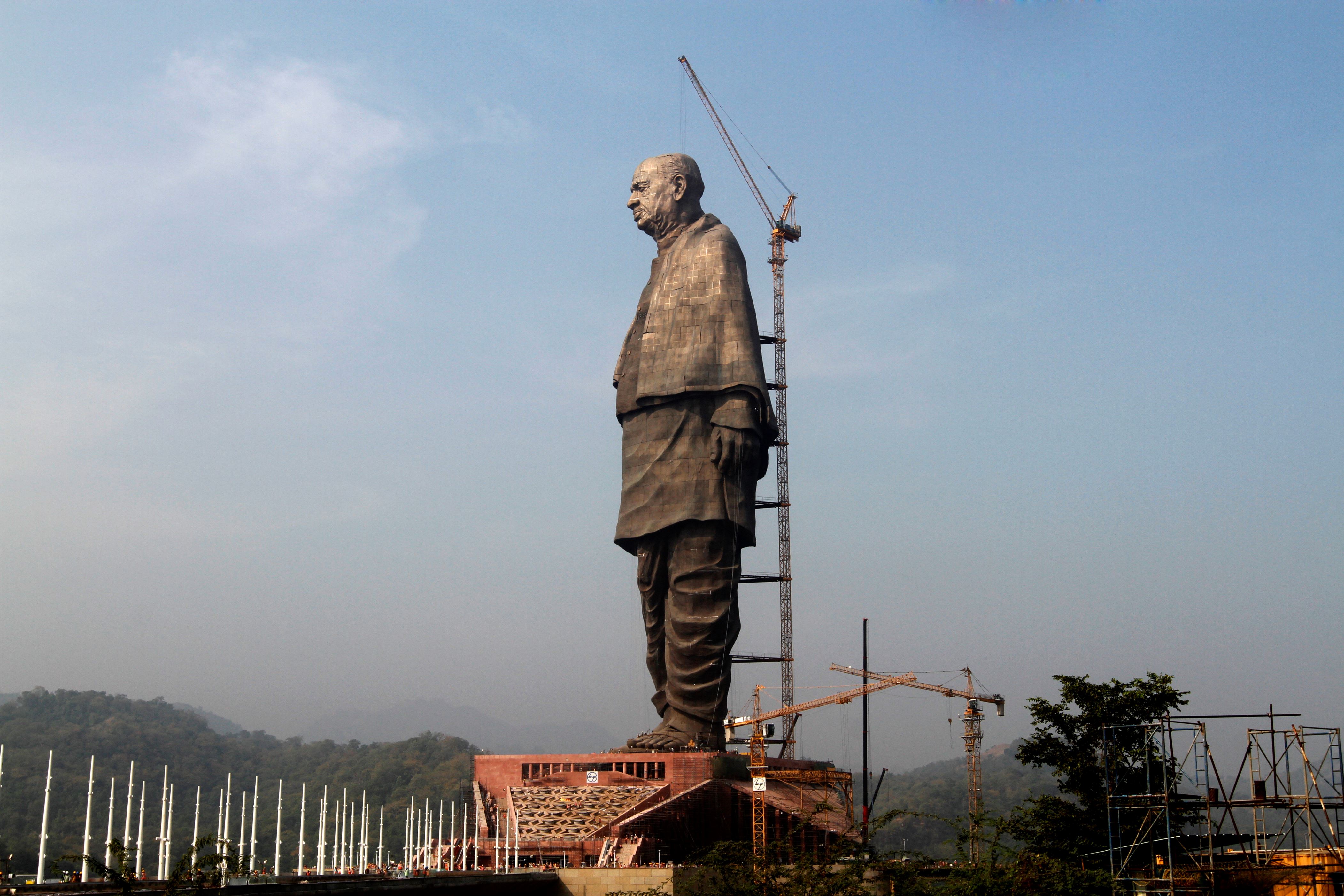 Slide 1 of 20: The under construction statue of unity stands facing Sardar Sarovar Dam is seen at Kevadiya Colony, about 200 kilometers (125 miles) from Ahmadabad, India, Thursday, Oct. 18, 2018. The Statue of Unity, a 182-meters tall tribute to Indian freedom fighter Sardar Vallabhbhai Patel, will be inaugurated on Oct. 31 by Indian Prime Minister Narendra Modi and is slated to be the one of the world's tallest statue. (AP Photo/Ajit Solanki)