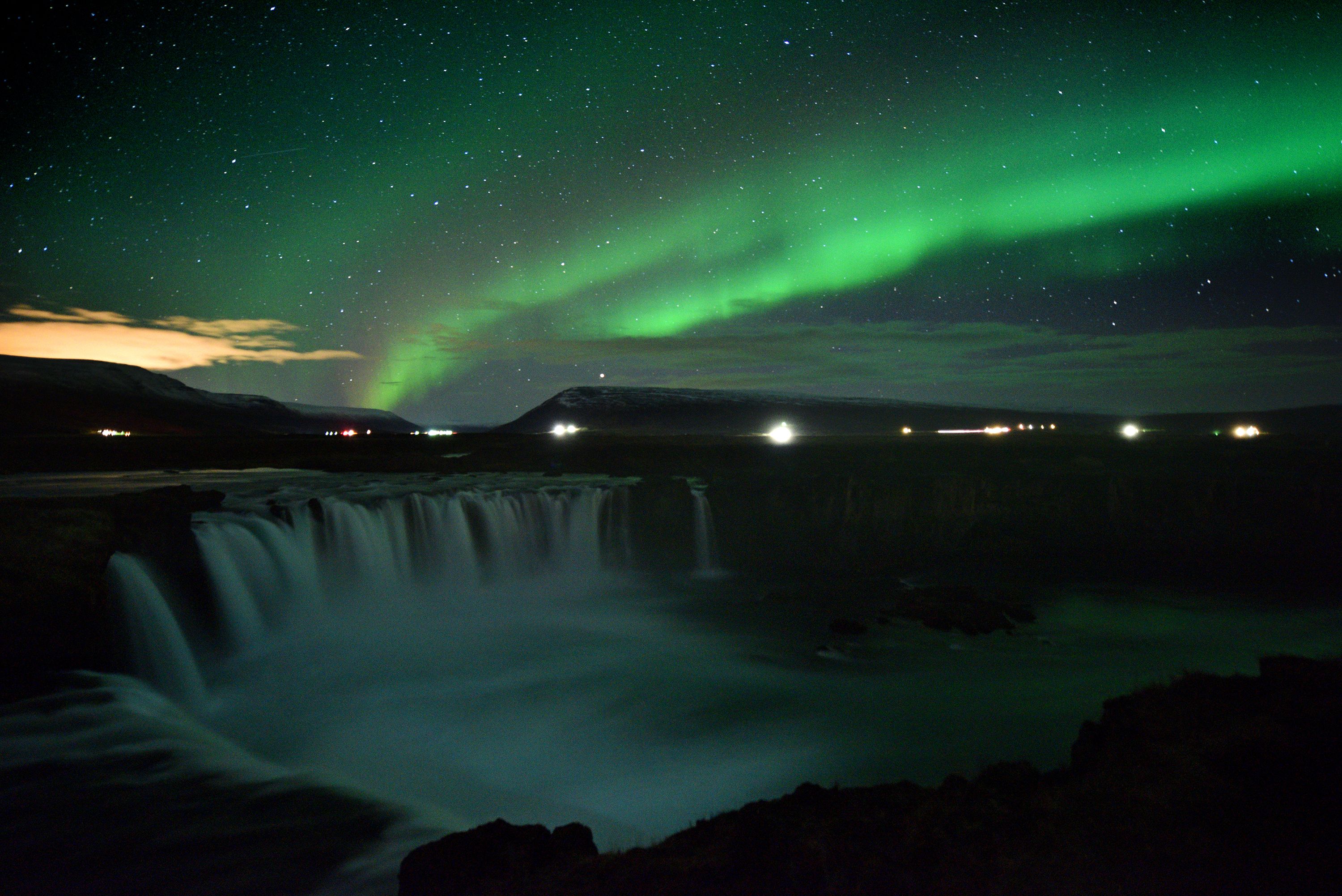 TOPSHOT - The aurora borealis, also known as Northern Lights, is seen over Godafoss waterfall, in the municipality of Thingeyjarsveit, east of Akureyri, in northern Iceland on October 14, 2018. (Photo by Mariana SUAREZ / AFP)        (Photo credit should read MARIANA SUAREZ/AFP/Getty Images)