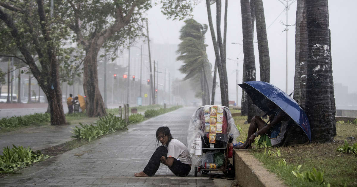 Philippines races to free 30 trapped in landslide; typhoon kills 7