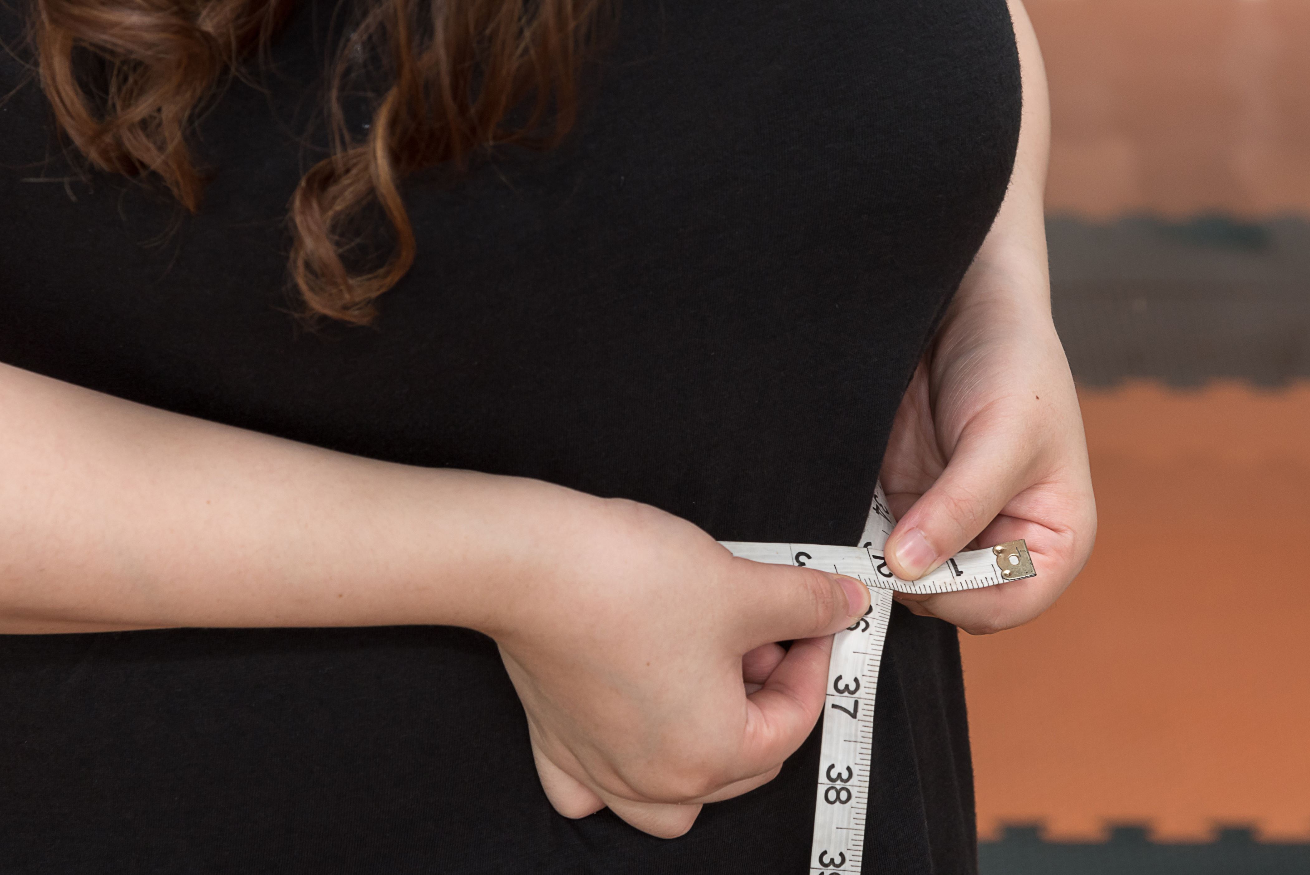 Woman Measuring Waist With Tape