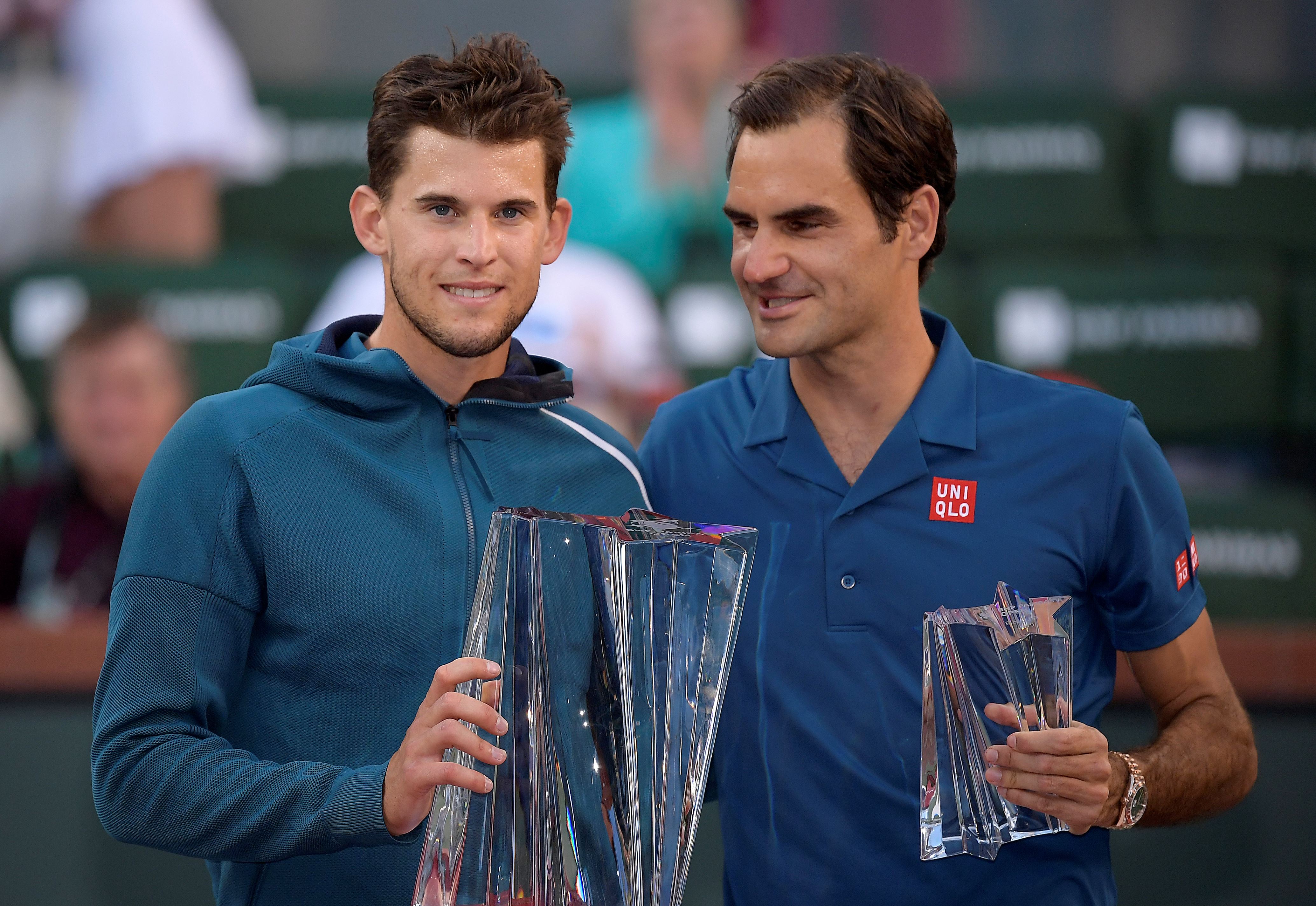 Dominic Thiem, of Austria, left, and Roger Federer, of Switzerland, pose with trophies after Thiem defeated Federer in the men's final at the BNP Paribas Open tennis tournament Sunday, March 17, 2019, in Indian Wells, Calif. Thiem won 3-6, 6-3, 7-5. (AP Photo/Mark J. Terrill)