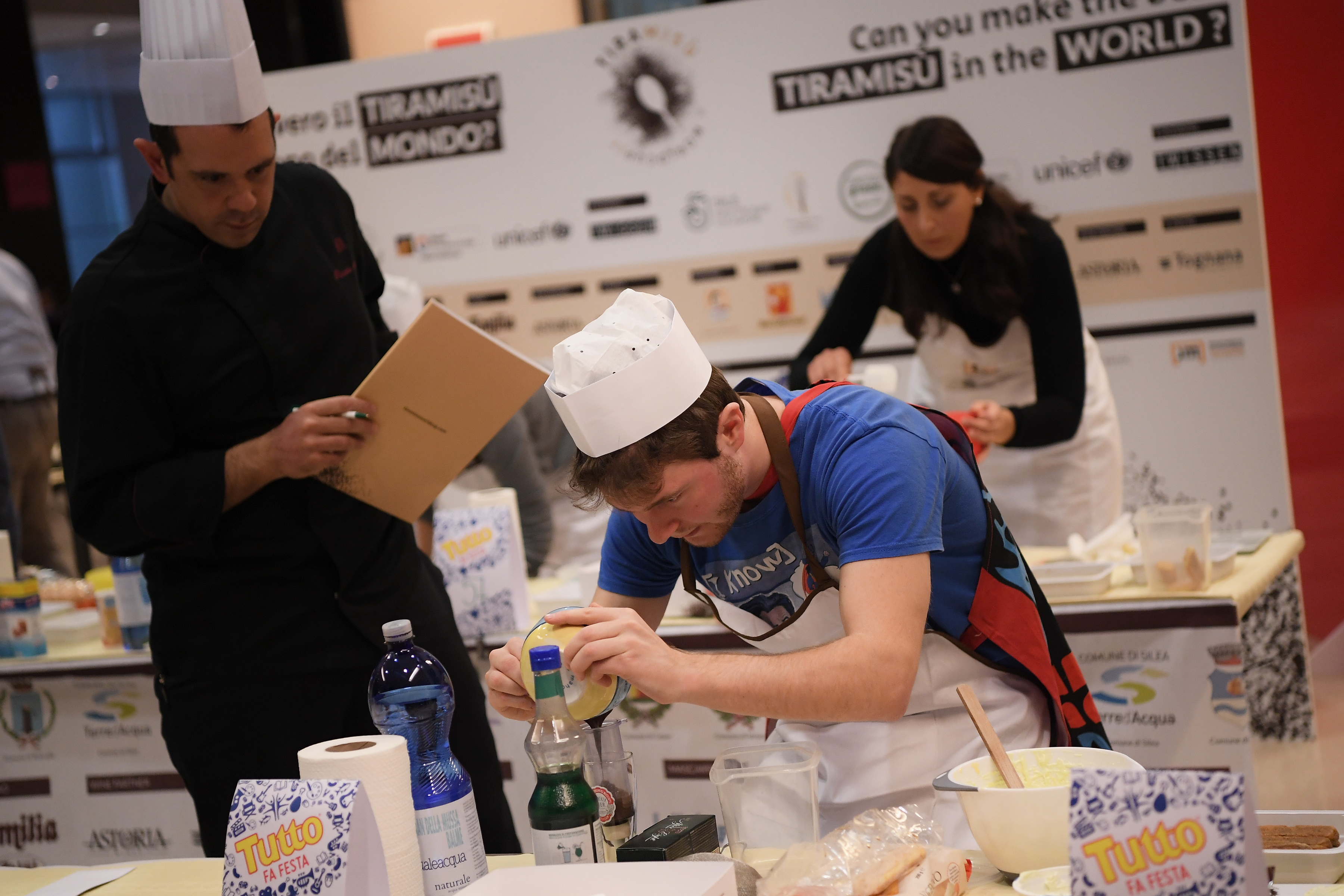 A judge watches as a competitor mixes ingredients together during the First Tiramisu World Cup on November 4, 2017 in Treviso.  / AFP PHOTO / MARCO BERTORELLO        (Photo credit should read MARCO BERTORELLO/AFP/Getty Images)