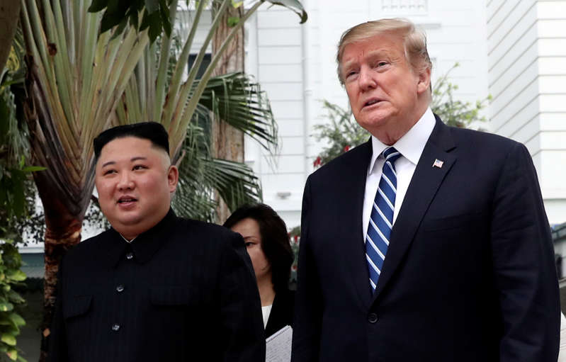 North Korea's leader Kim Jong Un and President Donald Trump walk in the garden of the Metropole hotel during the second North Korea-US summit in Hanoi, Vietnam.