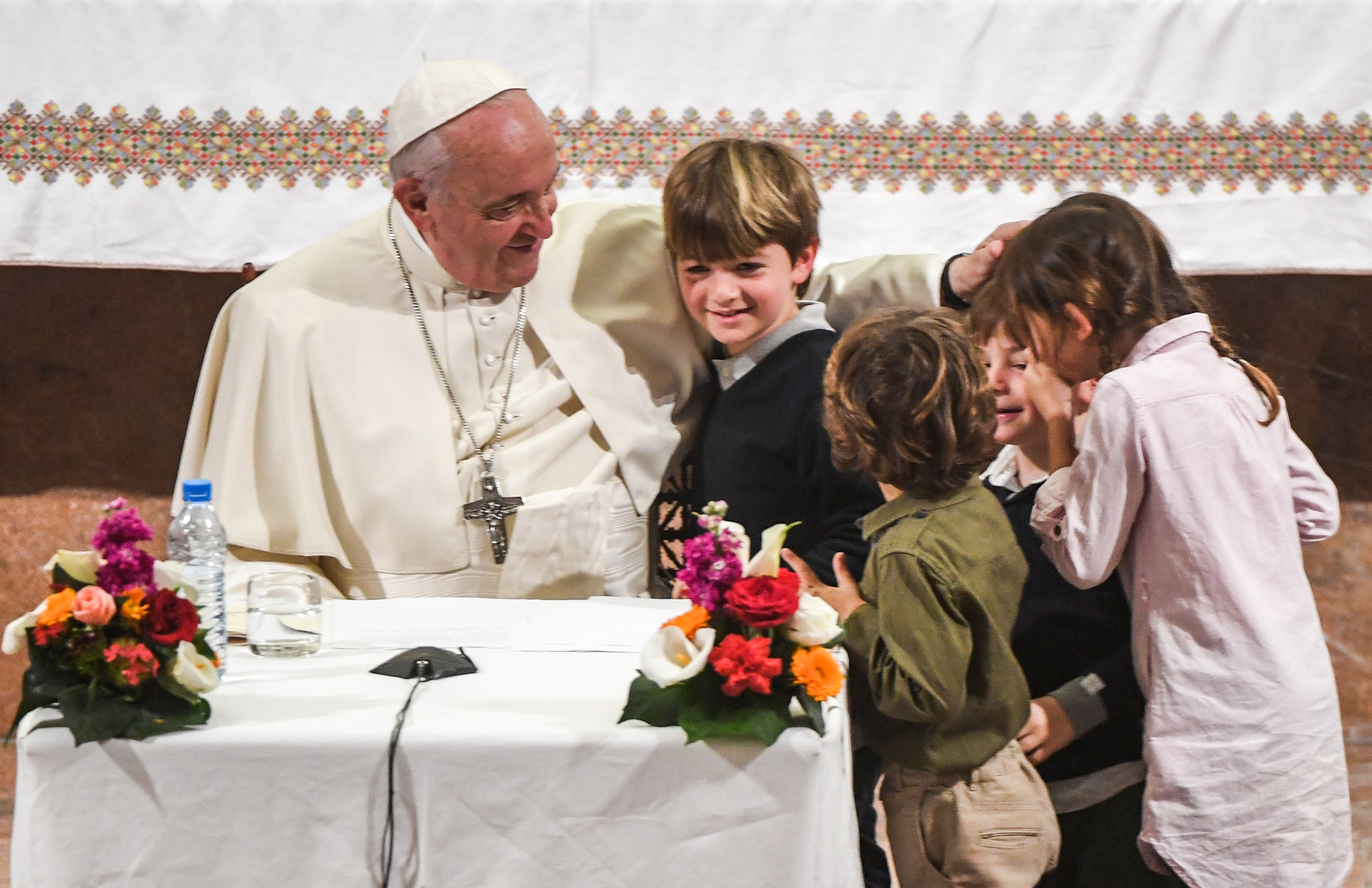 Pope Francis speaks with children during his meeting with members of the clergy  at St Peter's Roman Catholic Cathedral in the Moroccan capital Rabat on March 31, 2019, on the second day of the pontiff's two-day visit to Morocco. (Photo by FADEL SENNA / AFP)        (Photo credit should read FADEL SENNA/AFP/Getty Images)
