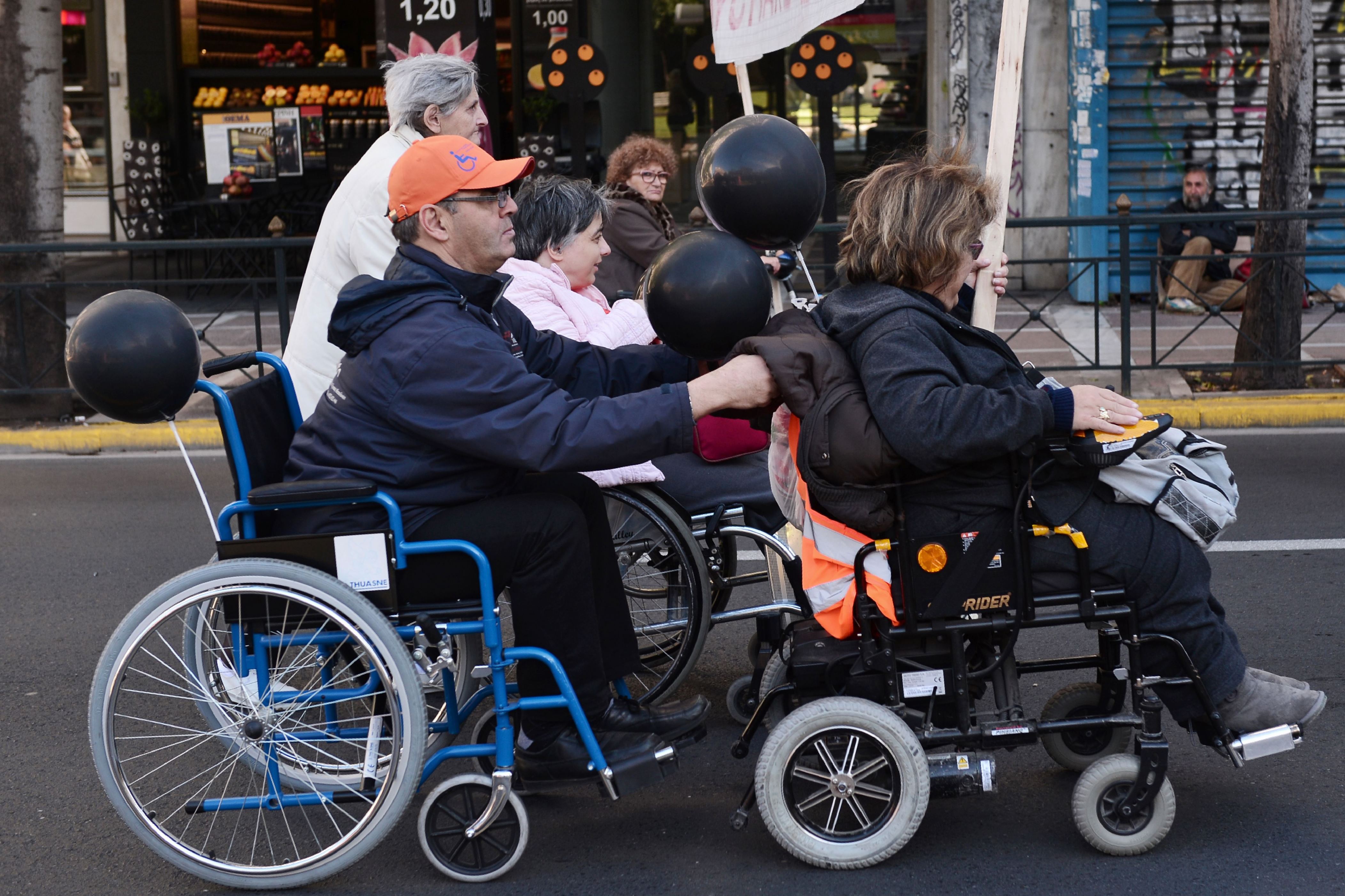 People with disabilities take part in a protest march during an anti-austerity rally in central Athens on December 2, 2016.
Unions and organisations representing the disabled and people with chronic diseases from across Greece joined the protest  against cutbacks in healthcare provisions, benefits and pensions.The rally was organized on the eve  of the International Day of Persons with Disabilities. / AFP / LOUISA GOULIAMAKI        (Photo credit should read LOUISA GOULIAMAKI/AFP/Getty Images)