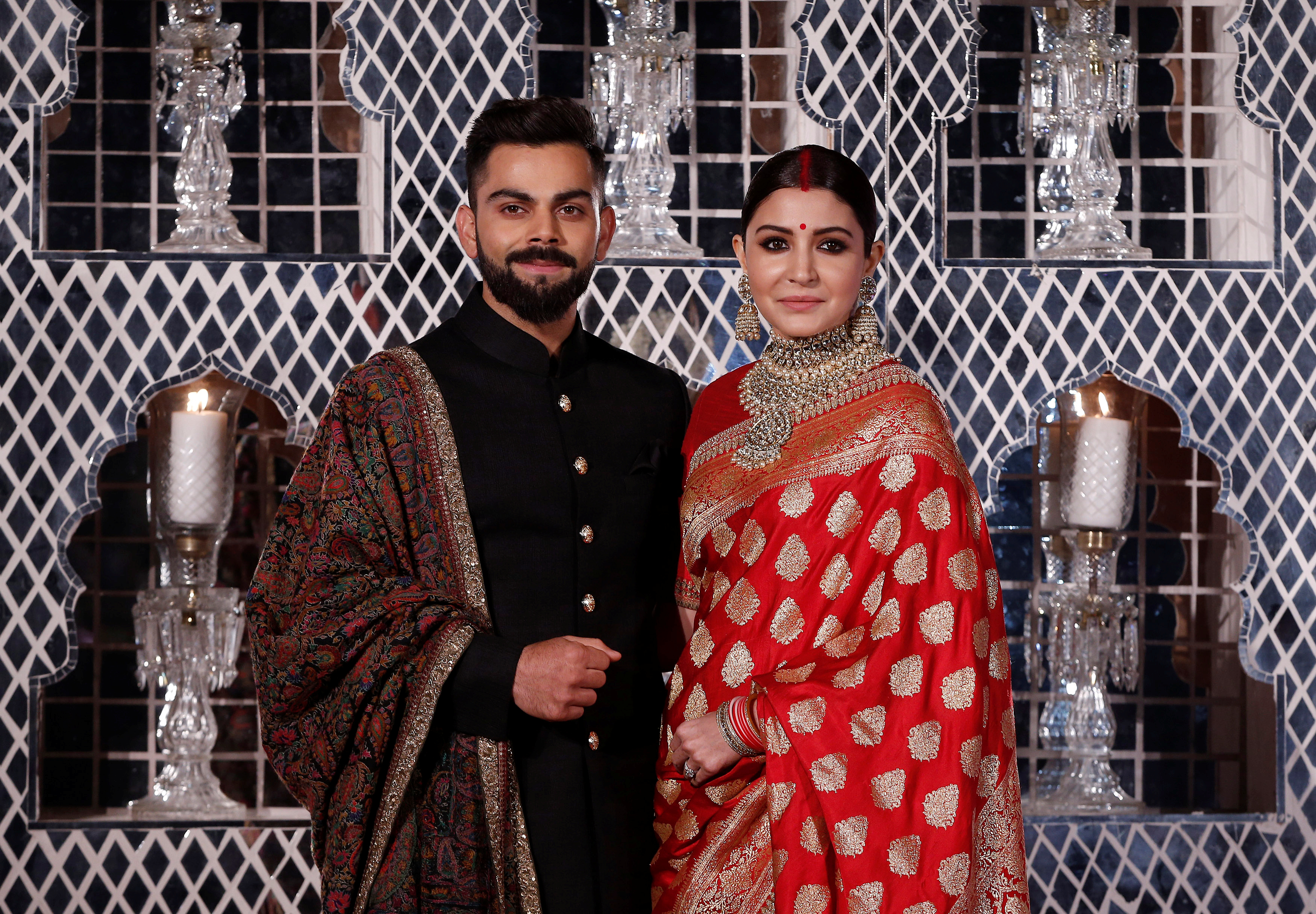 India's cricket team captain Virat Kohli (L) and his wife, Bollywood actress Anushka Sharma, pose during a photo oppurtunity at their wedding reception in New Delhi, India December 21, 2017.  REUTERS/Adnan Abidi