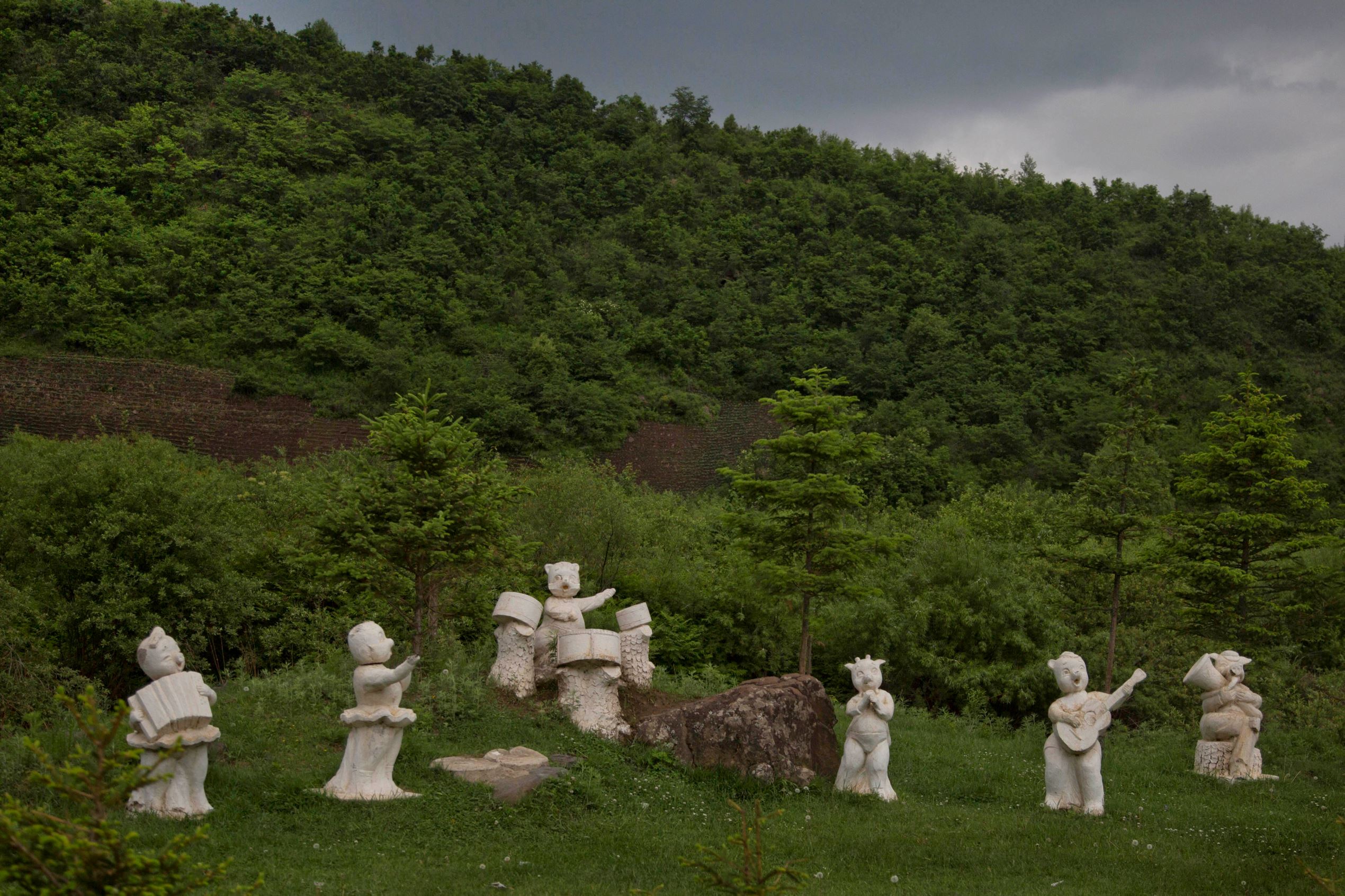Statues of animals playing musical instruments stand along the roadside south of Samsu, North Korea in Ryanggang province.