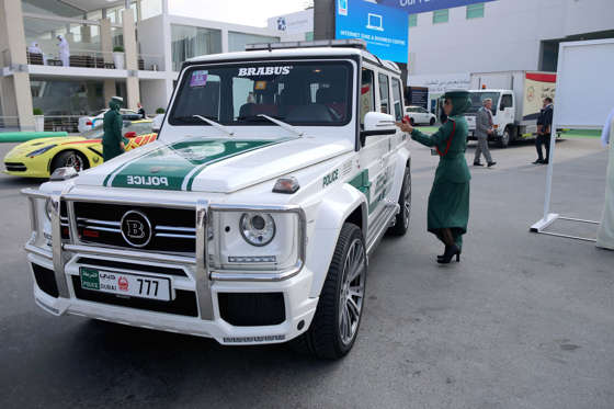 DUBAI, UNITED ARAB EMIRATES - NOVEMBER 18:  A Female Emerati police officer locks her Mercedes Benz Brabus 4x4 supercar during the Dubai Airshow on November 18, 2013 in Dubai, United Arab Emirates. The Dubai Air Show is the premier Middle East air show for trade and business delegates organized by F&E Aerospace.  (Photo by Christopher Furlong/Getty Images)