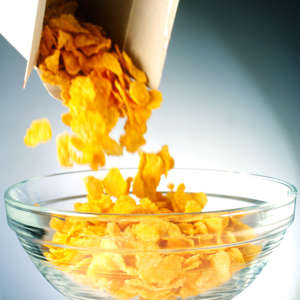 Cornflakes tumbling out of box and into bowl