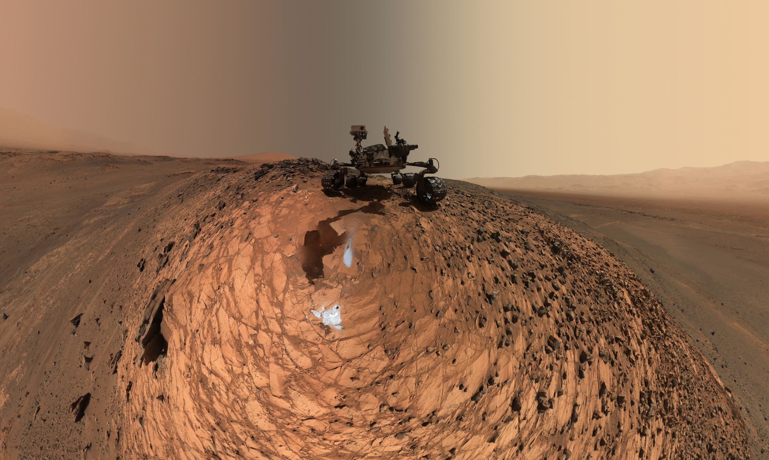 This low-angle self-portrait of NASA's Curiosity Mars rover shows the vehicle above the "Buckskin" rock target, where the mission collected its seventh drilled sample. The site is in the "Marias Pass" area of lower Mount Sharp.