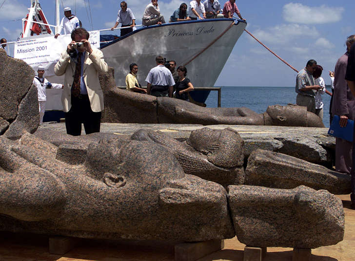Artifacts recovered from the submerged city of Heracleion lie on a barge at a naval base in Alexandria, Egypt, in 2001.