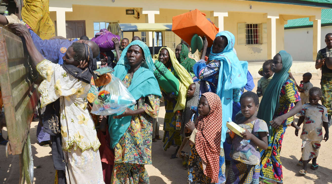 Women and children rescued by Nigerian soldiers from Boko Haram extremists in the northeast of Nigeria arrive at the military office in Maiduguri, Nigeria, Thursday, July 30, 2015. Soldiers rescued 71 people, almost all girls and women, in firefights that killed many Boko Haram militants in villages near the northeastern city of Maiduguri, Nigeria’s military said Thursday.