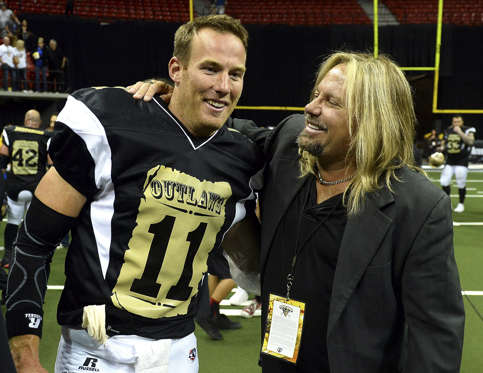 LAS VEGAS, NV - MAY 04:  Quarterback J.J. Raterink #11 of the Las Vegas Outlaws is congratulated by Motley Crue singer and team owner Vince Neil after the Outlaws defeated the Los Angeles Kiss 49-16 during their game at the Thomas & Mack Center on May 4, 2015 in Las Vegas, Nevada.  (Photo by Ethan Miller/Getty Images)