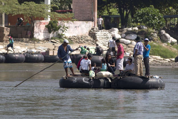 People are transported to the Guatemalan shore across the broad Suchiate river that separates, Tecun Uman, Guatemala and Ciudad Hidalgo, Mexico, on July 11, 2014.