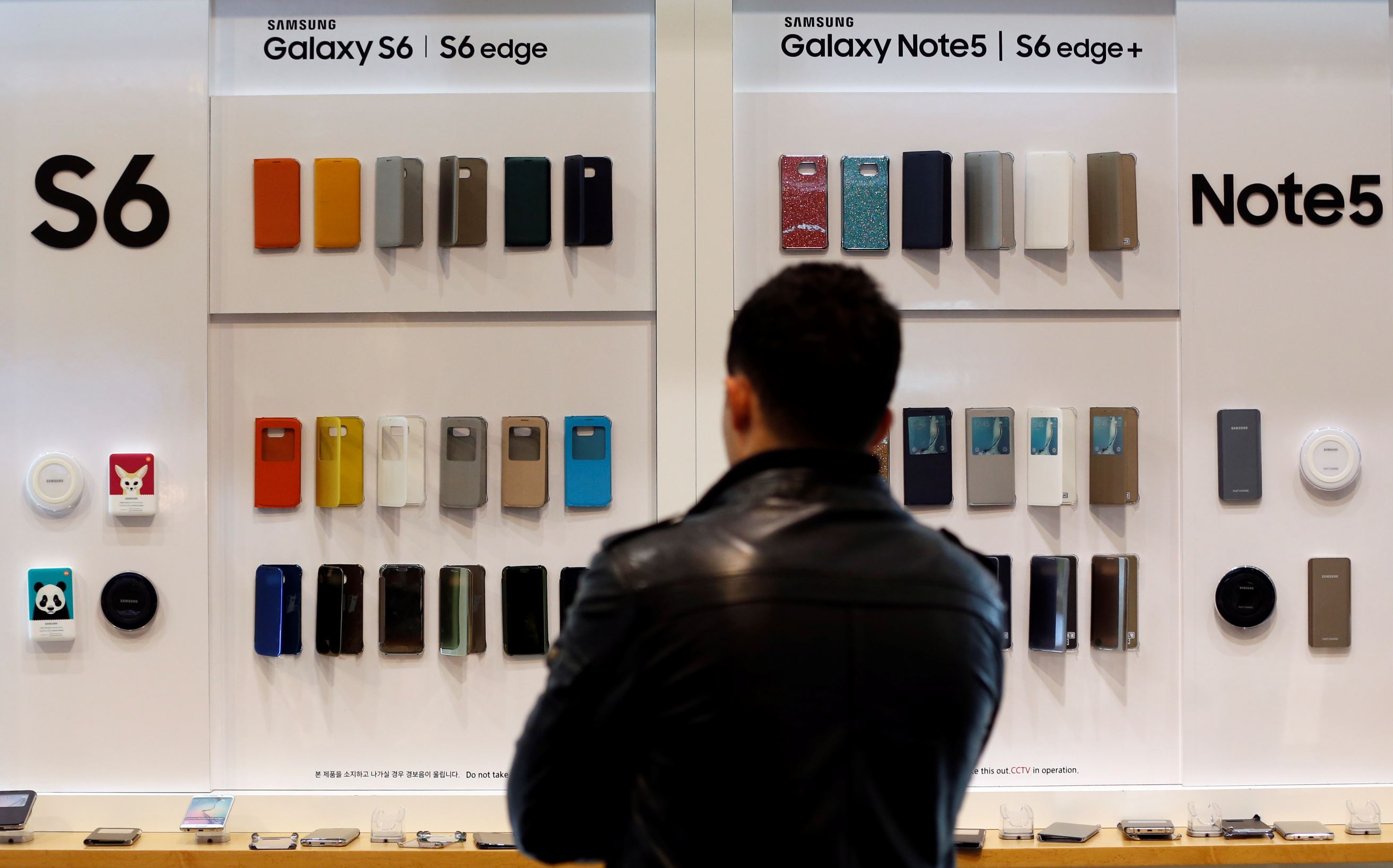 A visitor stands in front of Samsung Electronics's smartphone cases at its shop in Seoul, South Korea, Thursday, Oct. 29, 2015.