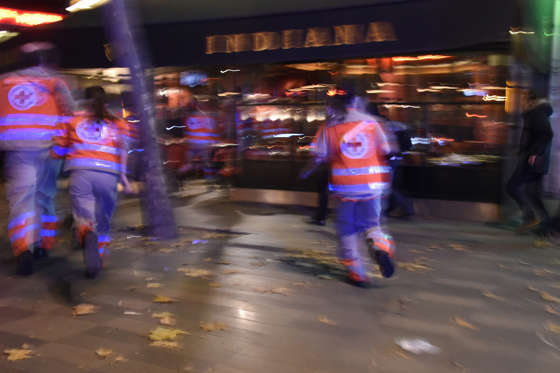 People run after hearing what is believed to be explosions or gun shots near Place de la Republique square in Paris on November 13, 2015. At least 18 people were killed in several shootings and explosions in Paris today, police said. AFP PHOTO / DOMINIQUE FAGET (Photo credit should read DOMINIQUE FAGET/AFP/Getty Images)