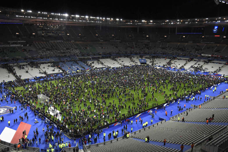 Spectators gather on the pitch of the Stade de France stadium following the friendly football match between France and Germany in Saint-Denis, after a series of gun attacks occurred across Paris as well as explosions outside the national stadium.
