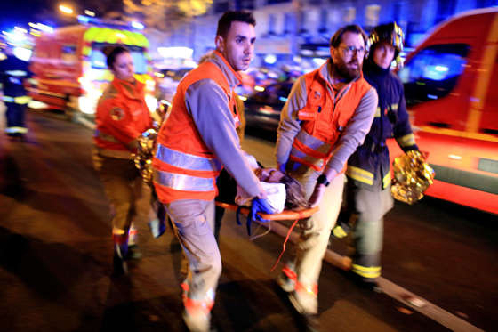 People are evacuated from the Bataclan theater after a shooting on Nov. 13, 2015, in Paris.